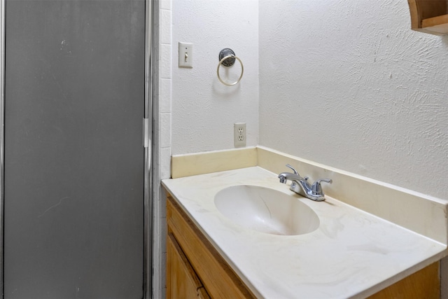 bathroom with an enclosed shower and vanity