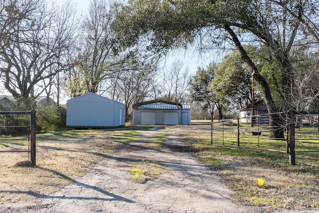 view of yard featuring a garage and an outdoor structure