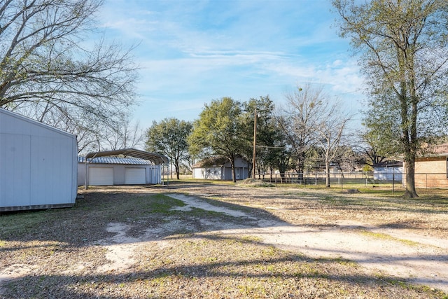 view of yard featuring an outdoor structure and a carport