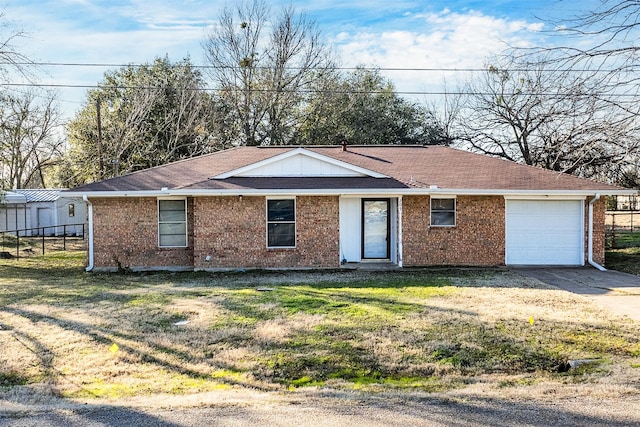 ranch-style house featuring a front yard and a garage