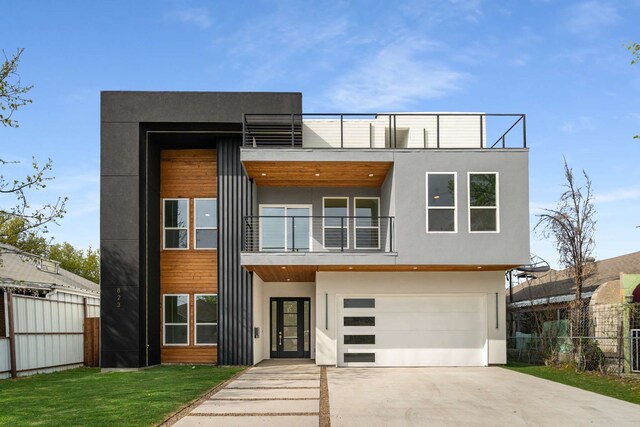 modern home with a garage and a balcony