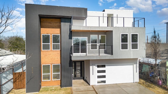 contemporary house with a balcony and a garage