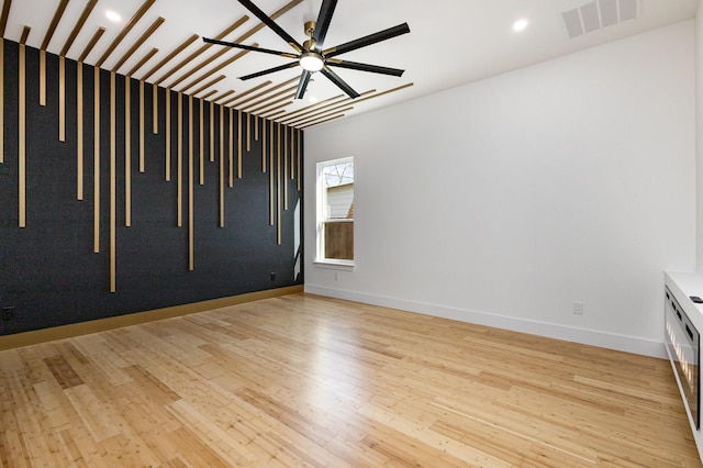 empty room featuring ceiling fan and light hardwood / wood-style floors