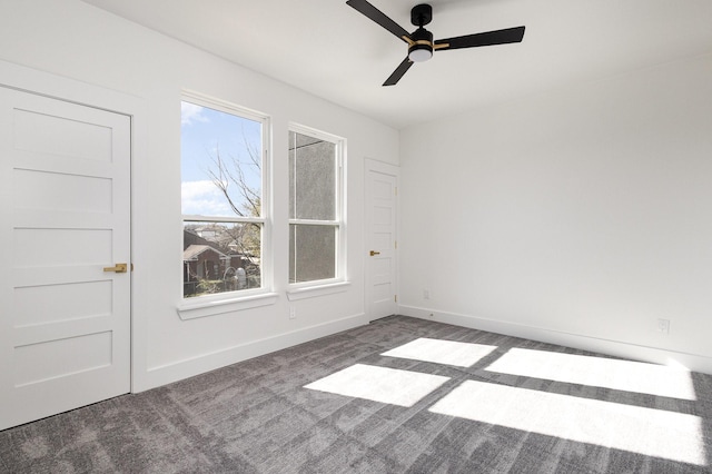 carpeted empty room featuring ceiling fan