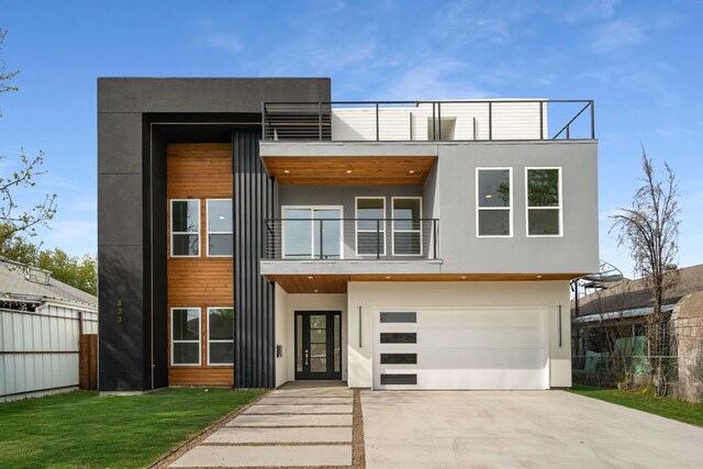 modern home with a garage and a balcony