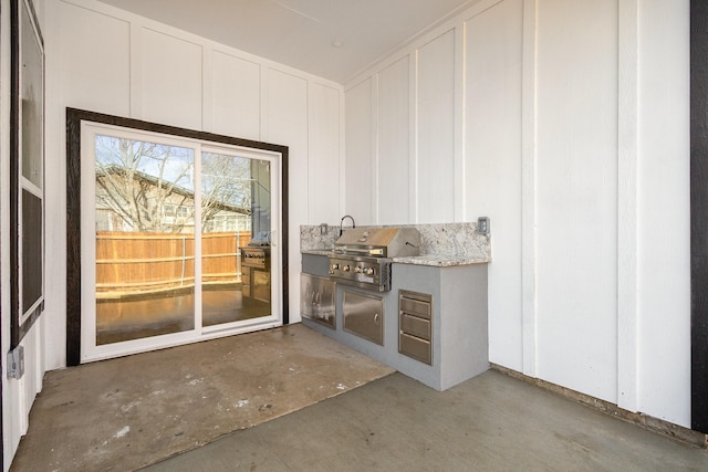 interior space featuring white cabinets and concrete flooring