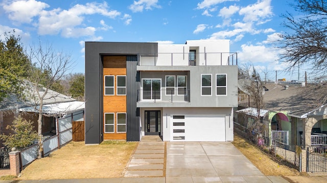 modern home with a garage and a balcony