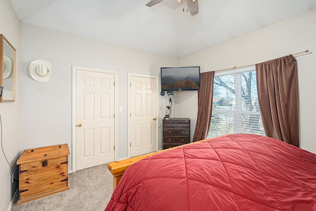 carpeted bedroom with vaulted ceiling and ceiling fan