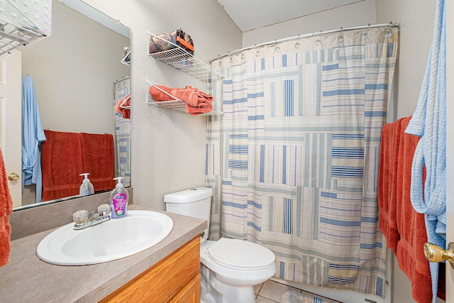 bathroom with a shower with curtain, vanity, tile patterned floors, and toilet