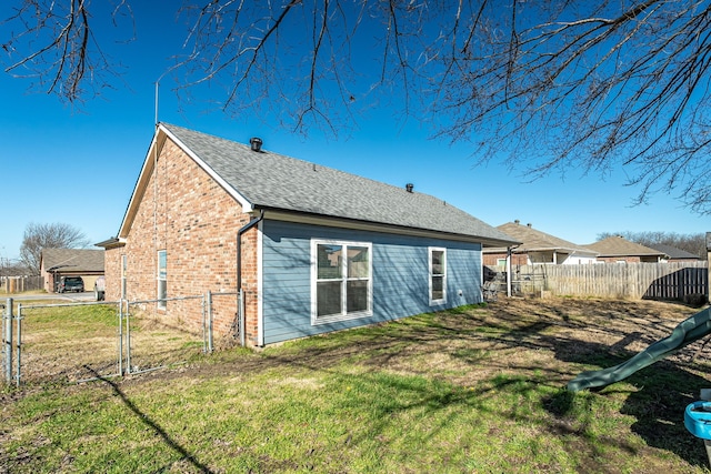 rear view of house with a yard