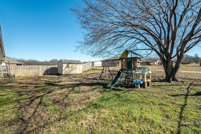 view of yard featuring a playground and a shed