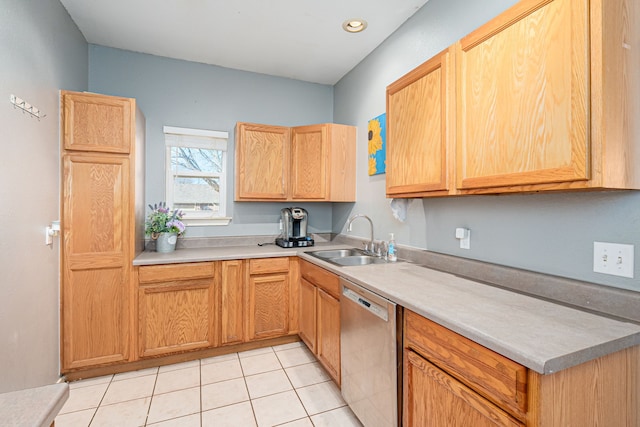 kitchen featuring dishwasher, sink, and light tile patterned flooring