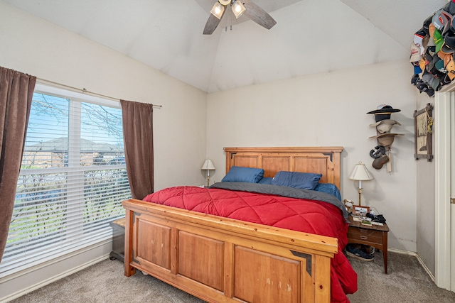 carpeted bedroom with ceiling fan and vaulted ceiling