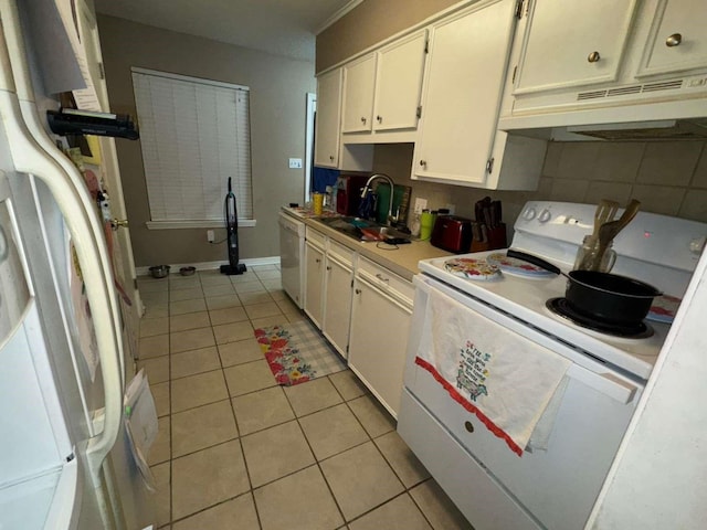 kitchen featuring light tile patterned floors, sink, white appliances, and white cabinetry