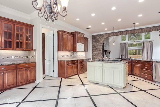 kitchen featuring pendant lighting, a center island, white microwave, an inviting chandelier, and light tile patterned floors