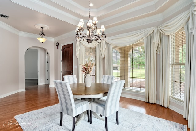 9356 Dogwood Trl, Haughton, LA 71037 - dining space with arched walkways, wood finished floors, visible vents, and ornamental molding