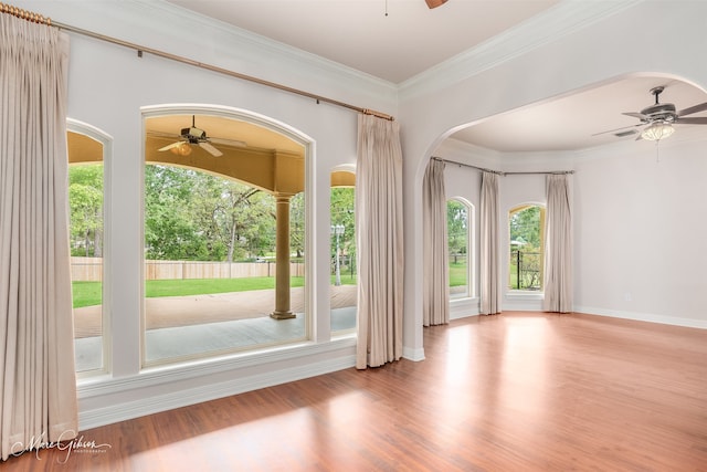 interior space with light wood-type flooring, ceiling fan, and crown molding