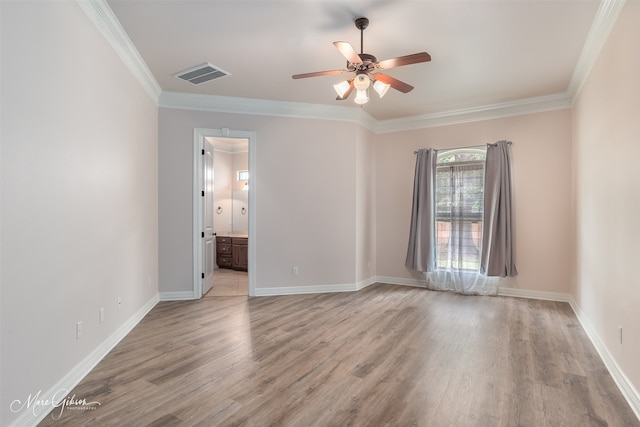 empty room with ceiling fan, crown molding, and light hardwood / wood-style flooring