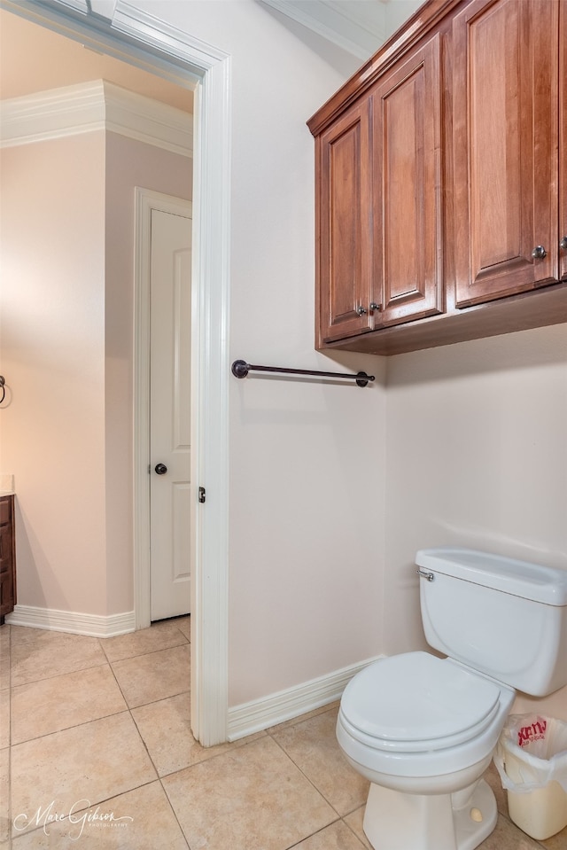 bathroom featuring toilet, vanity, tile patterned flooring, and crown molding