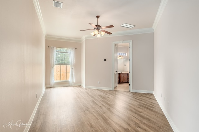 spare room with ceiling fan, light hardwood / wood-style flooring, and crown molding