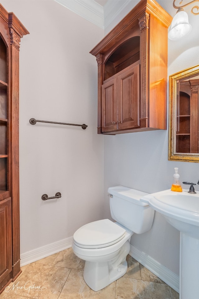 bathroom with tile patterned floors, toilet, and ornamental molding