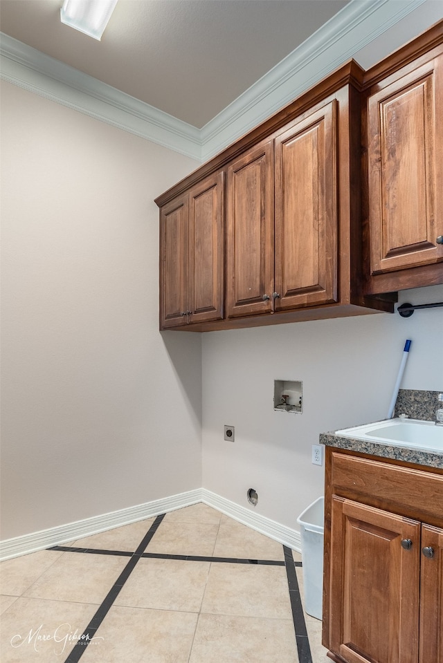 clothes washing area featuring cabinets, electric dryer hookup, ornamental molding, hookup for a washing machine, and light tile patterned floors