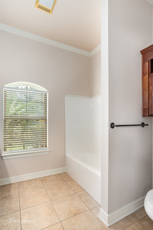 bathroom with a bath, toilet, tile patterned flooring, and crown molding