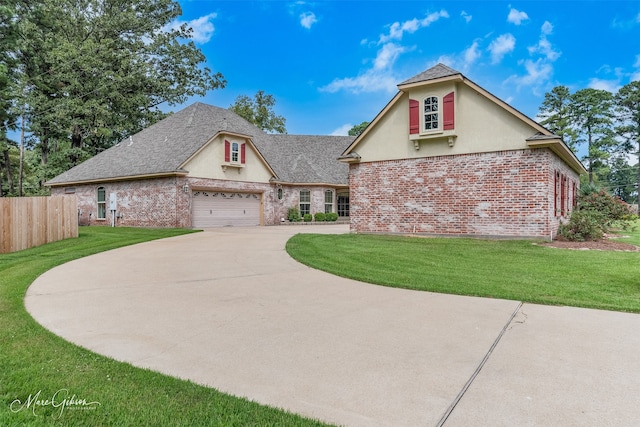 view of front of house with a front lawn and a garage