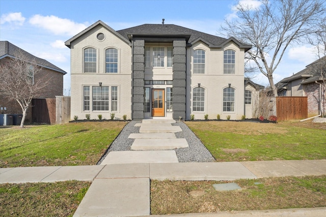 view of front of house featuring a front yard and central air condition unit