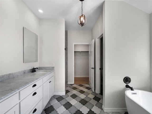 bathroom featuring a tub to relax in and vanity