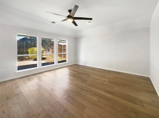 empty room featuring hardwood / wood-style flooring and ceiling fan