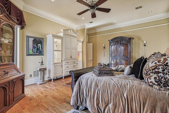 bedroom featuring light wood finished floors, visible vents, and crown molding