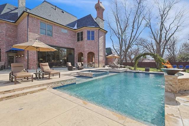 view of swimming pool with a patio area and an in ground hot tub