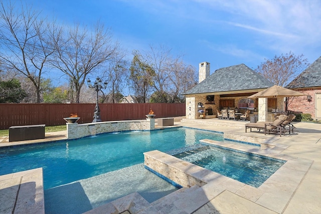 view of swimming pool featuring an in ground hot tub, an outbuilding, pool water feature, and a patio