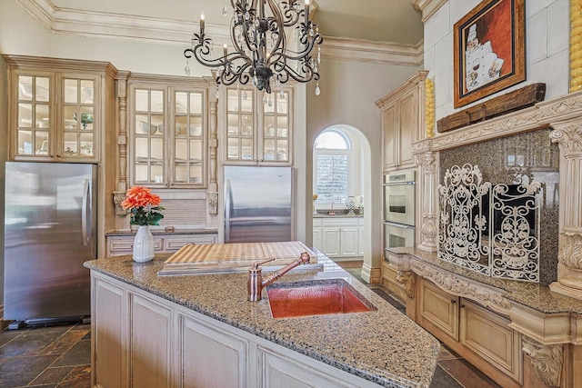 kitchen featuring light stone countertops, a center island, stainless steel appliances, sink, and hanging light fixtures