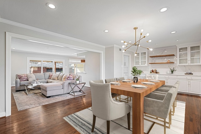 dining area featuring an inviting chandelier, crown molding, and hardwood / wood-style flooring