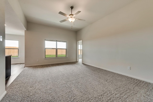 carpeted spare room featuring ceiling fan