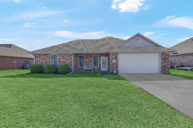 ranch-style home with a front lawn, central AC unit, and a garage