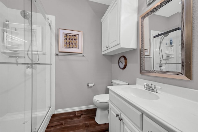 bathroom featuring an enclosed shower, vanity, and toilet