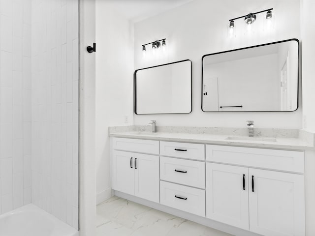 full bath with double vanity, marble finish floor, shower / tub combination, and a sink