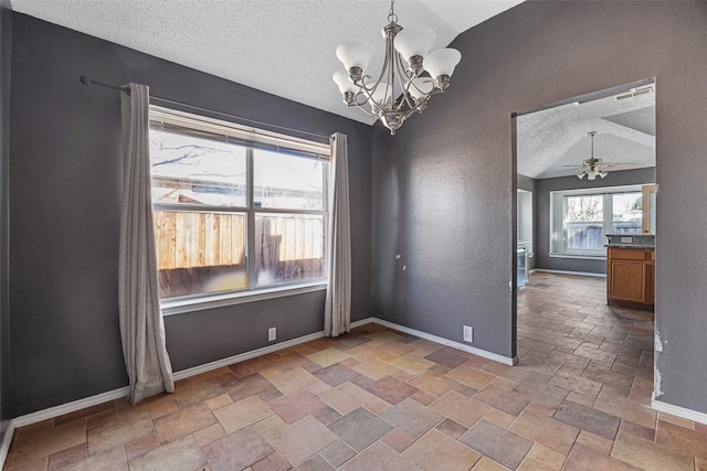 unfurnished dining area featuring vaulted ceiling, ceiling fan with notable chandelier, and a textured ceiling