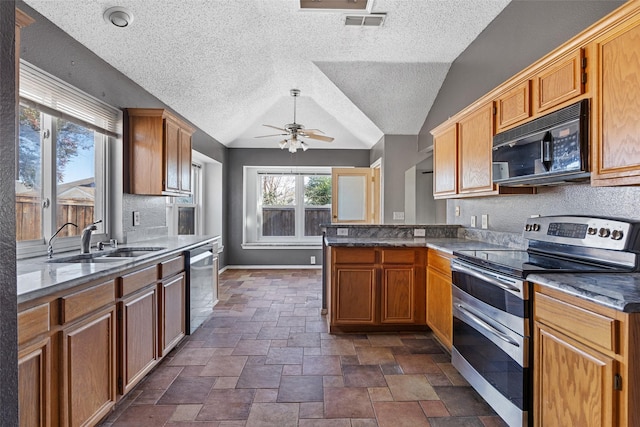 kitchen featuring lofted ceiling, ceiling fan, kitchen peninsula, sink, and appliances with stainless steel finishes