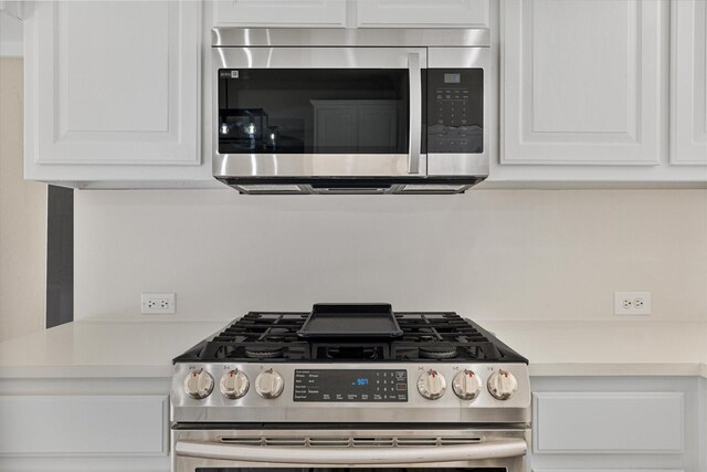 kitchen with white cabinetry and appliances with stainless steel finishes