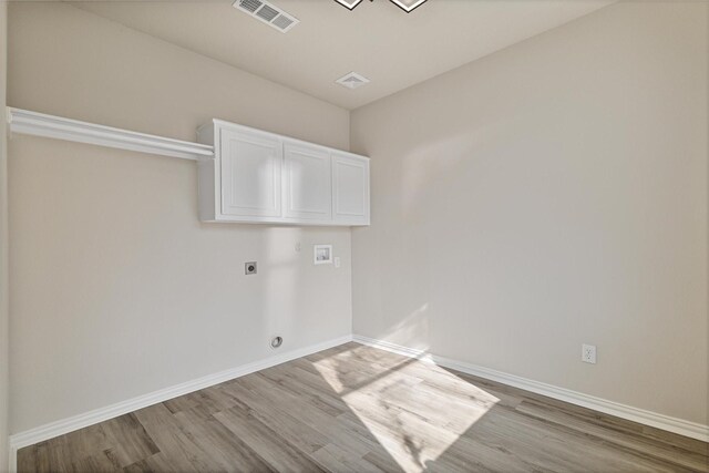 washroom featuring washer hookup, cabinets, light wood-type flooring, and electric dryer hookup