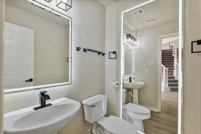 bathroom with toilet, sink, and hardwood / wood-style flooring