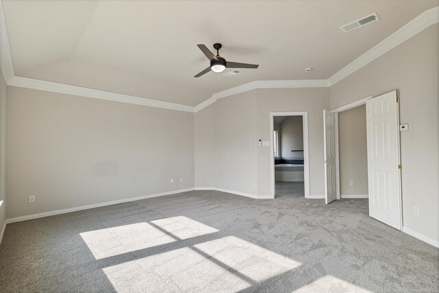 unfurnished bedroom with ceiling fan, lofted ceiling, ensuite bath, crown molding, and light carpet