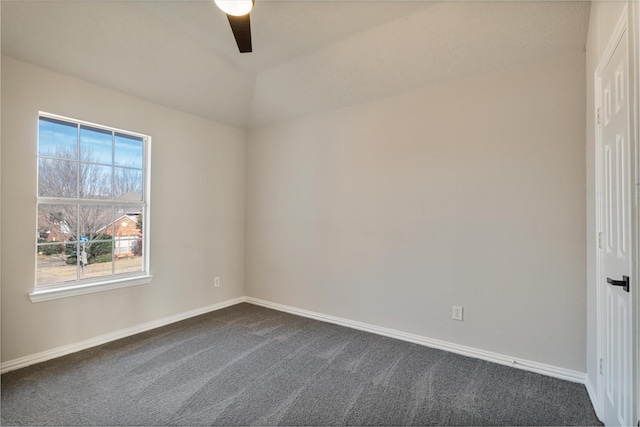 spare room featuring lofted ceiling, ceiling fan, and dark colored carpet