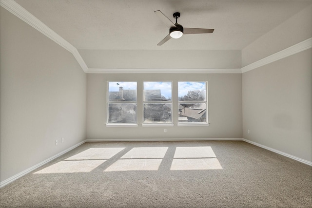 spare room featuring ceiling fan, a wealth of natural light, crown molding, and light carpet