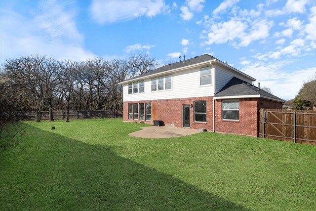 rear view of house with a patio area and a lawn