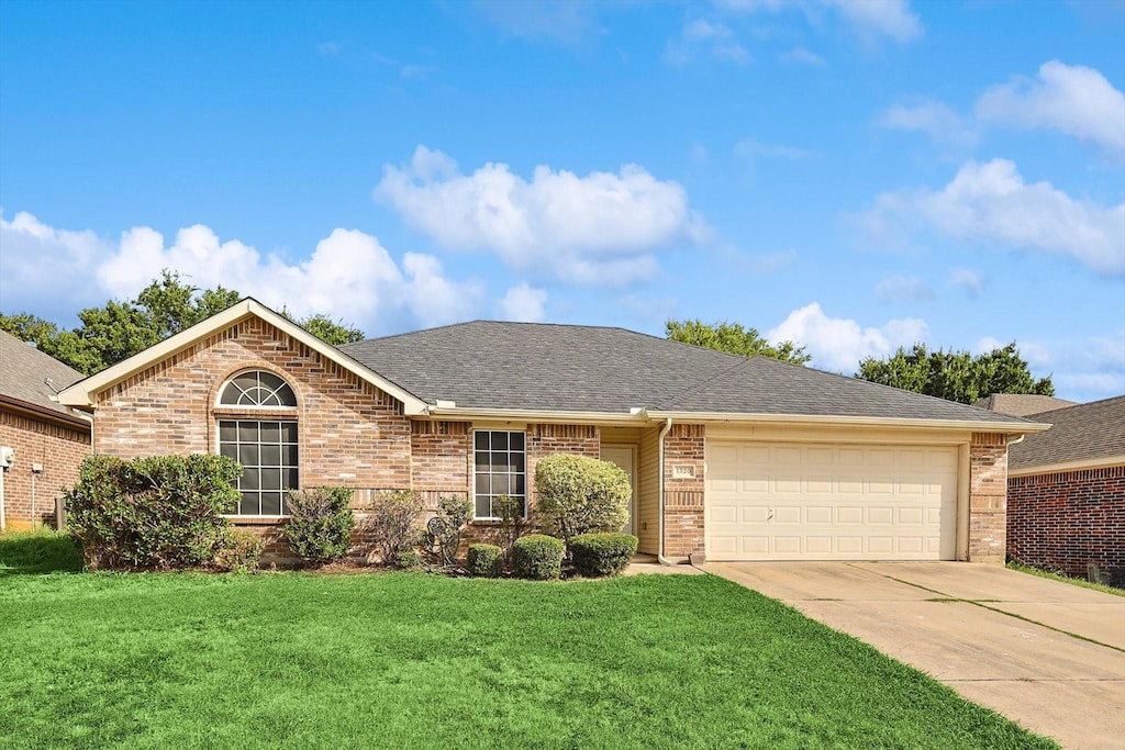 ranch-style home with a front yard and a garage